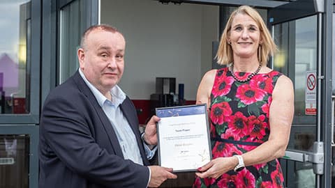 Peter Beszter receiving an award from Jan Godsell.