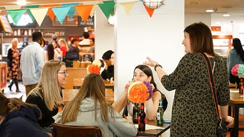 Staff and students chatting at the undergraduate finalist meal.