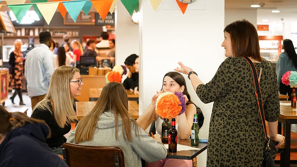 Staff and students chatting at the undergraduate finalist meal.