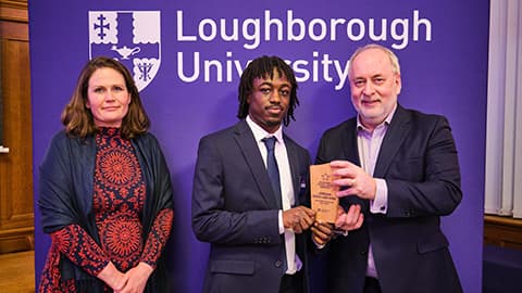 Jordan Addo-Antoine receiving an award from Nick Jennings and Justine Wood.