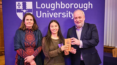 Fawn Pu receiving an award from Nick Jennings and Justine Wood.