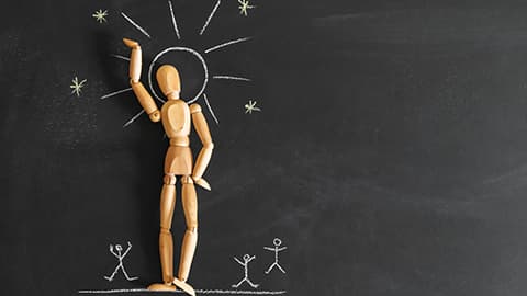 Concept of narcissism and selfishness. Wooden man on the background of chalk board.