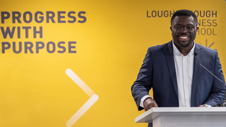 A speaker introduces the Loughborough Business School Black History Month event.