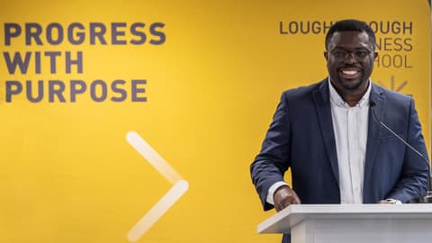 A speaker introduces the Loughborough Business School Black History Month event.