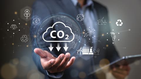 A man standing with palm outstretched and graphical representations of climate related icons around them.