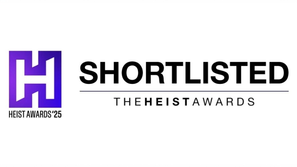 Logo and text for the Heist Awards 2025. A stylized purple and white 'H' logo appears on the left, with bold black text reading 'SHORTLISTED' to the right, and smaller text below stating 'THE HEIST AWARDS'