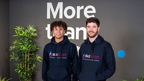 Henry Brogan and Tyler McCarthy in BidScript branded hoodies.