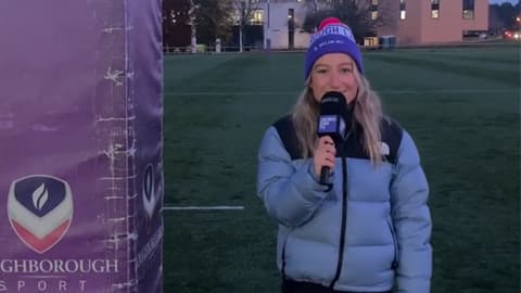 Bella Harris-Johnstone standing outside on a sports pitch with a microphone.
