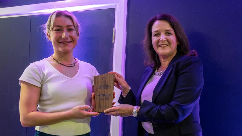 Bella Harris-Johnstone receiving an award from Jo Jennings.