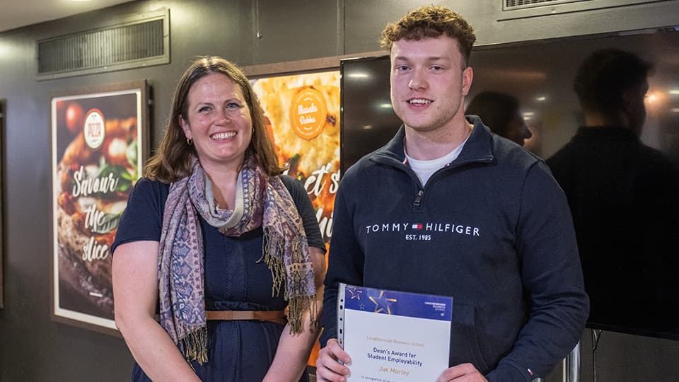 Justine Wood and Jak Morley, with Jak holding an award certificate.
