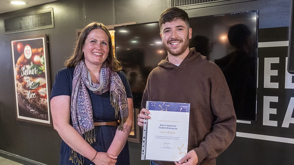 Justine Wood and Henry Brogan, with Henry holding an award certificate.