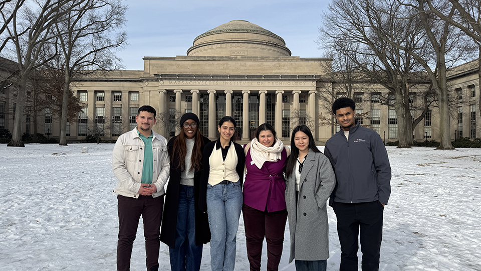Group of UK SCALE students standing in front of the Massachusetts Institute of Technology’s Great Dome on a snowy day.