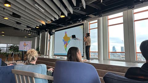 Nivetha delivering a presentation on stage.