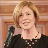 Clara Neppel standing in front of a microphone