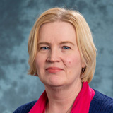 Jaana Pinnick wearing a red blouse and dark suit jacket