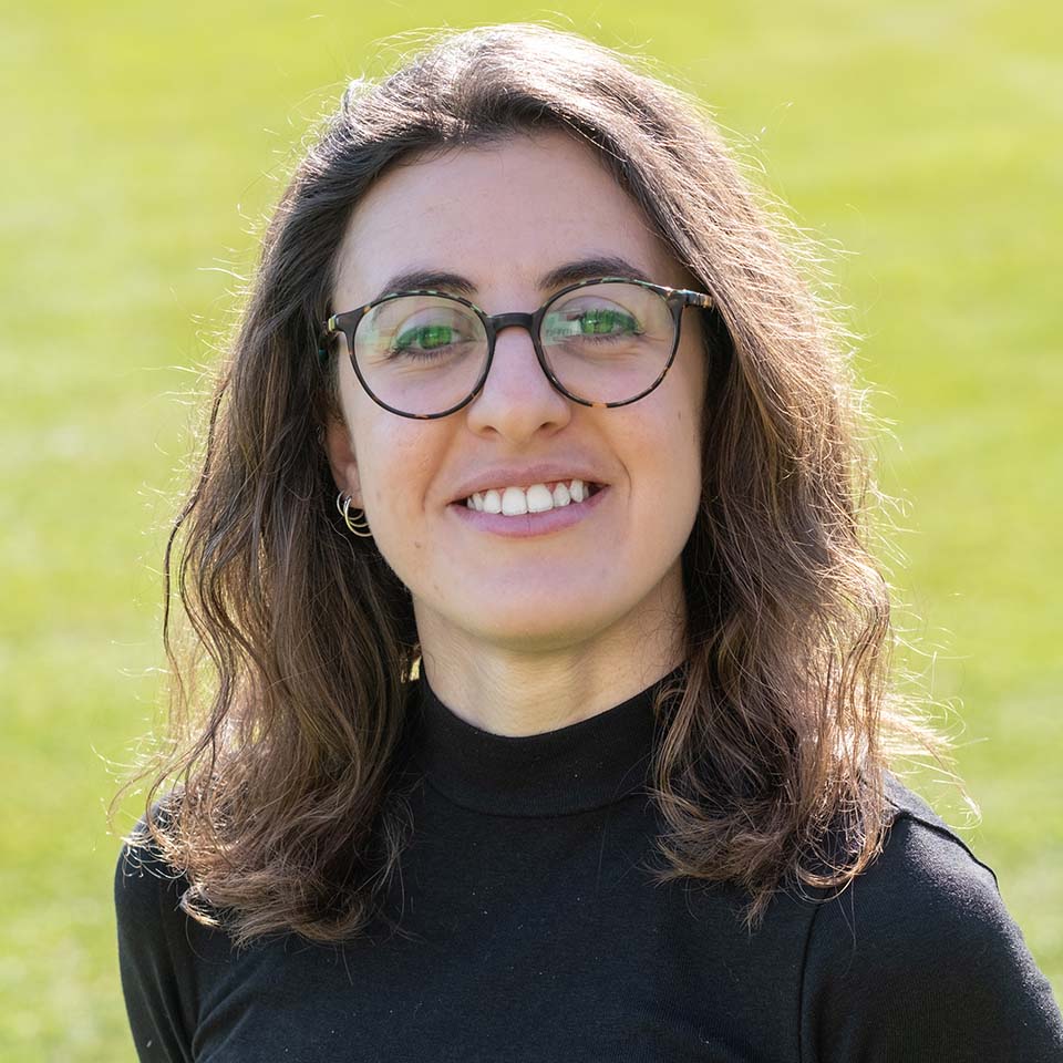 A portrait of Thomai Papadopoulou standing on grass