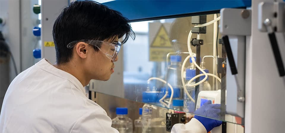 James working in the lab wearing goggles