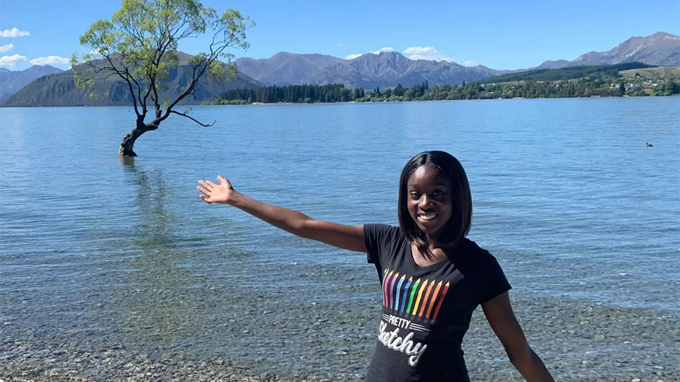 Uche in Auckland standing in front of lake and mountains