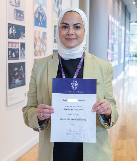Dua - Dennis Holt Travel Prize Winner holding her certificate