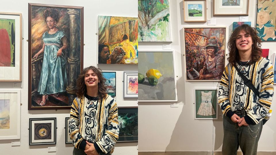 Tom Hudson standing in front of his work