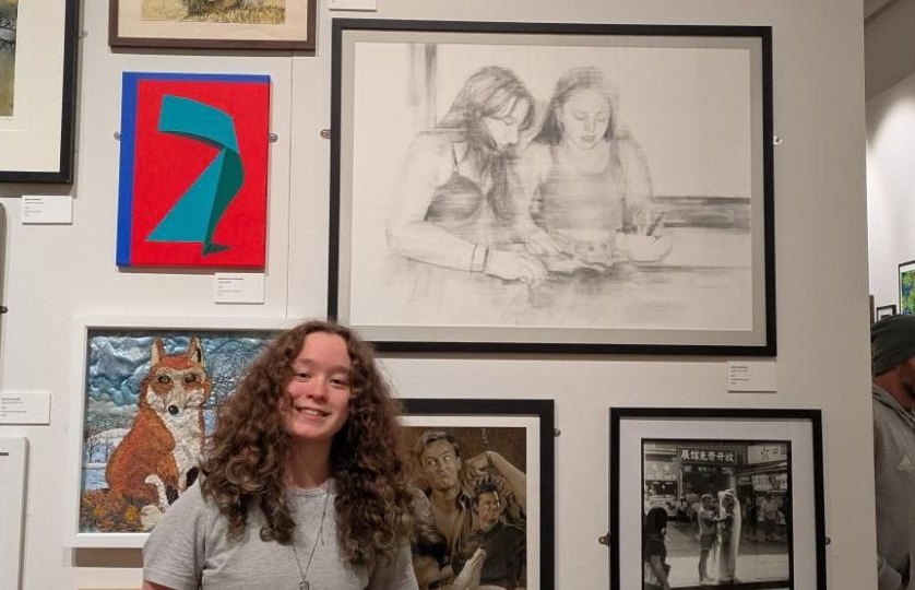 Heidi Greathead standing in front of her work