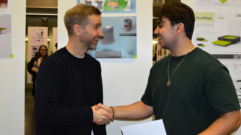 Gareth from Joseph Joseph shaking hands with winning student