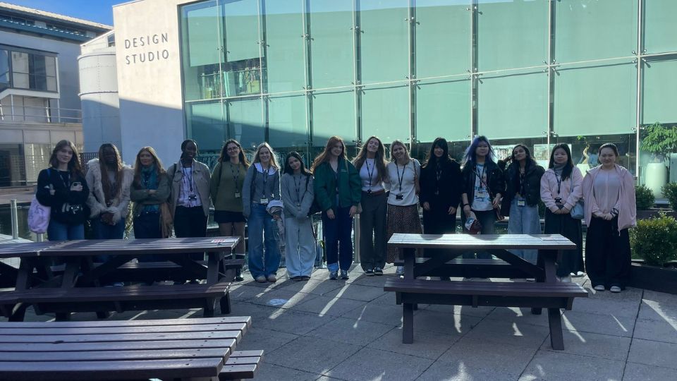 Fashion Design students in a group photo in front of NEXT design studios