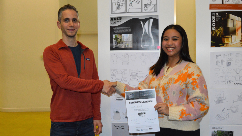 Lynne Ukrit accepting an award for 1st place from Kohler Mira