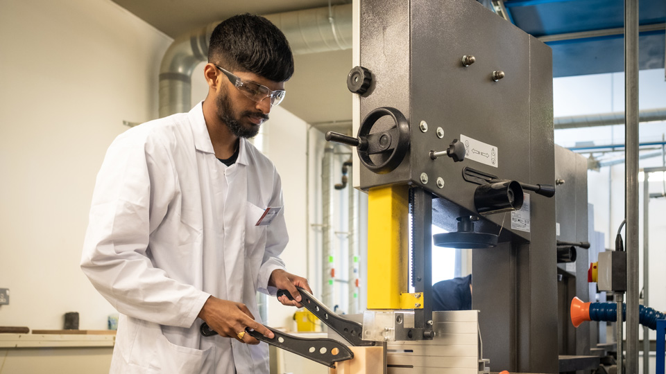 A student working on machinery