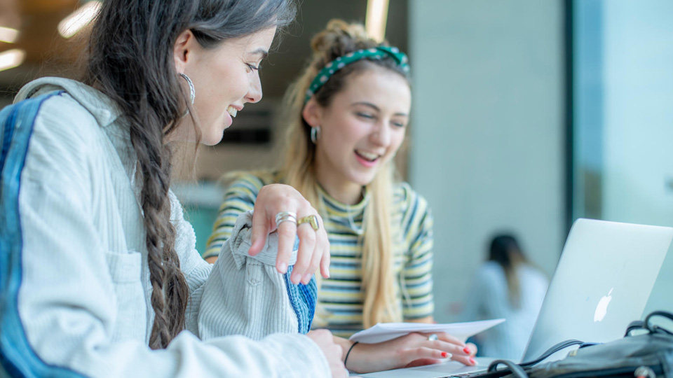 Students looking at a laptop