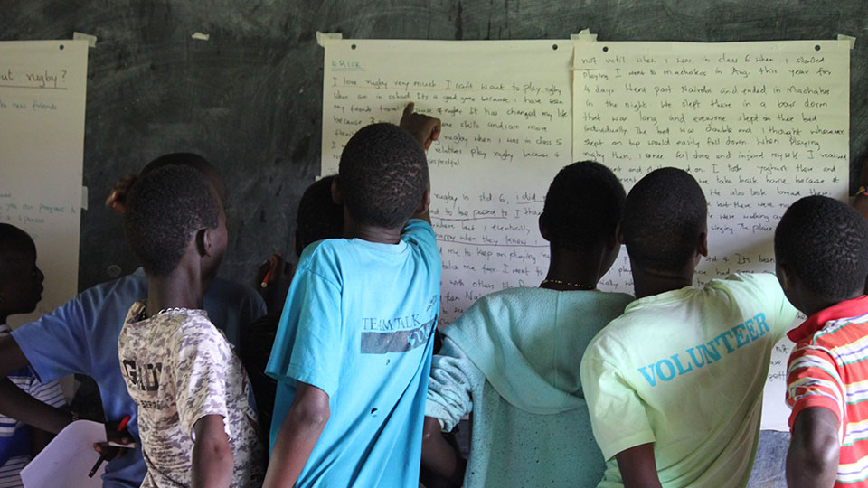 a group of children reading a classroom white board