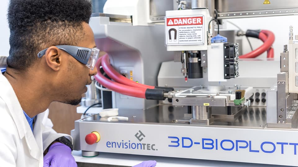 male student looking at equipment