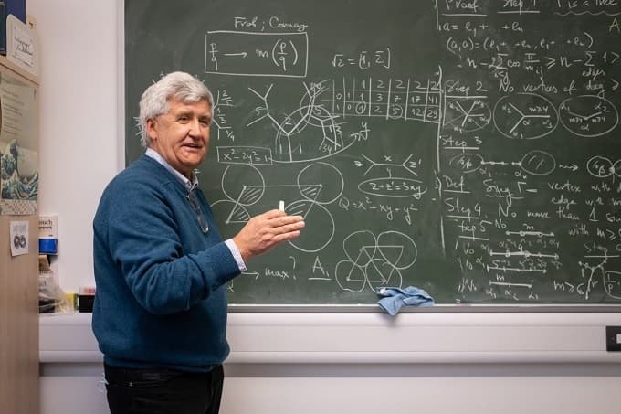 a professor in front of a blackboard