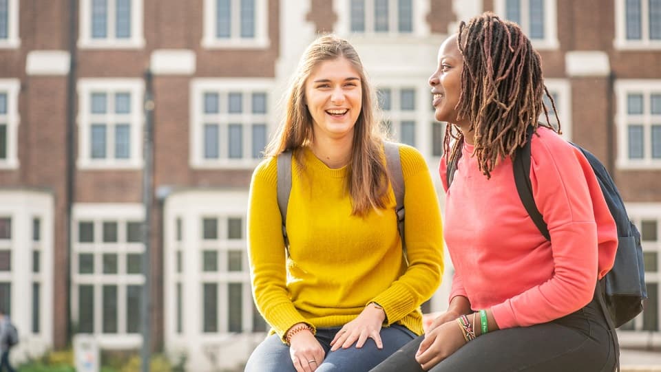 two people in front of a campus