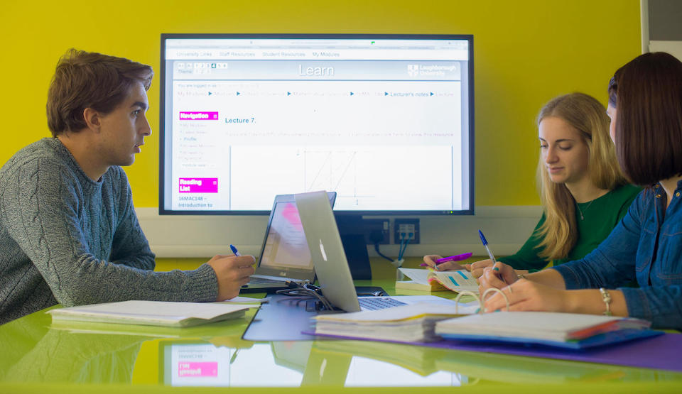 a group of students sitting around a desk