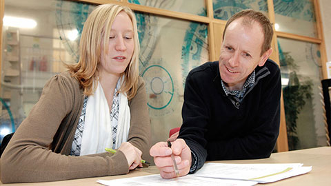 Alun Owen in discussion with a colleague