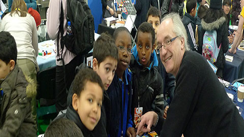a tutor posing for a photo with pupils at the Big Bang Science Fair