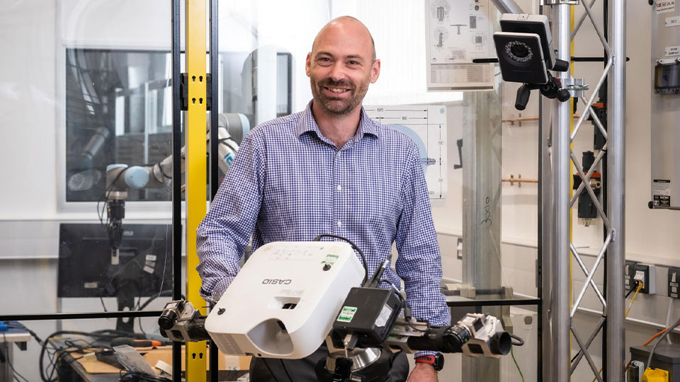 Peter smiling in an engineering lab
