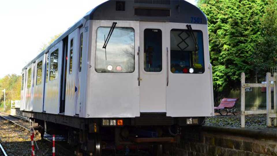 Single train passenger stationary on a train track. 