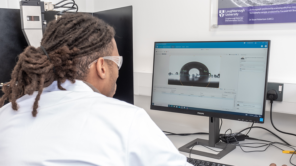 Alex on the computer in a engineering lab