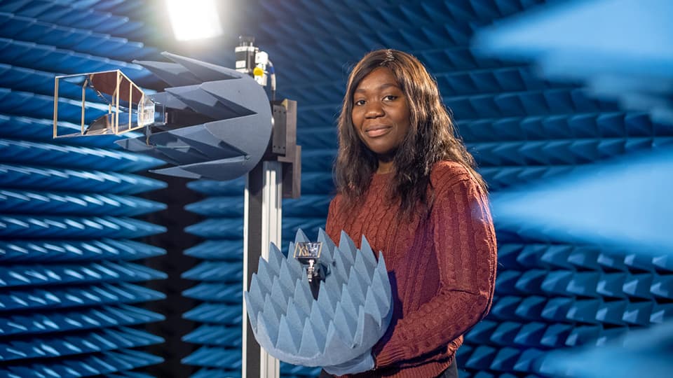 Student in lab with electrical engineering equipment