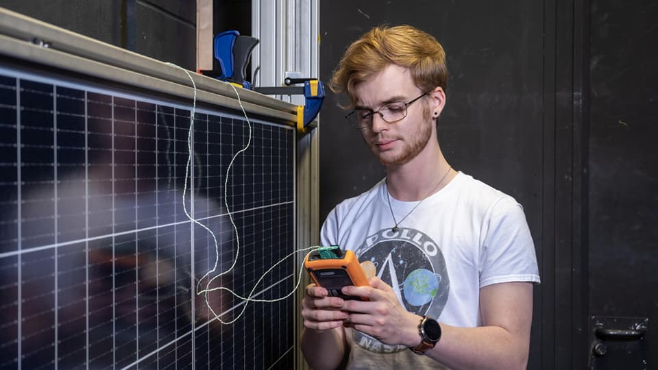 Student in engineering lab testing solar panels