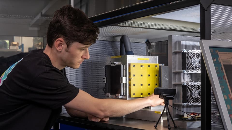 Student in engineering lab working with energy equipment