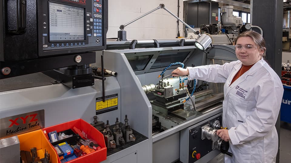 Students in engineering lab working on engineering equipment