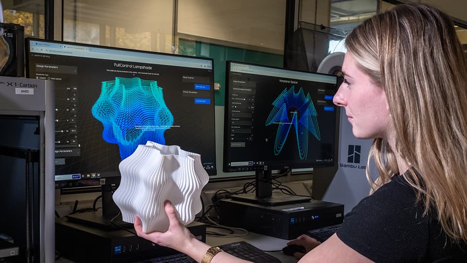 Student in engineering lab working on a computer with a 3D object