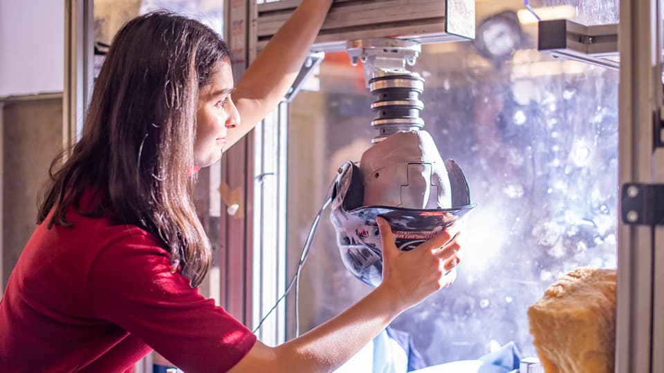 Student in sports engineering lab testing sports equipment