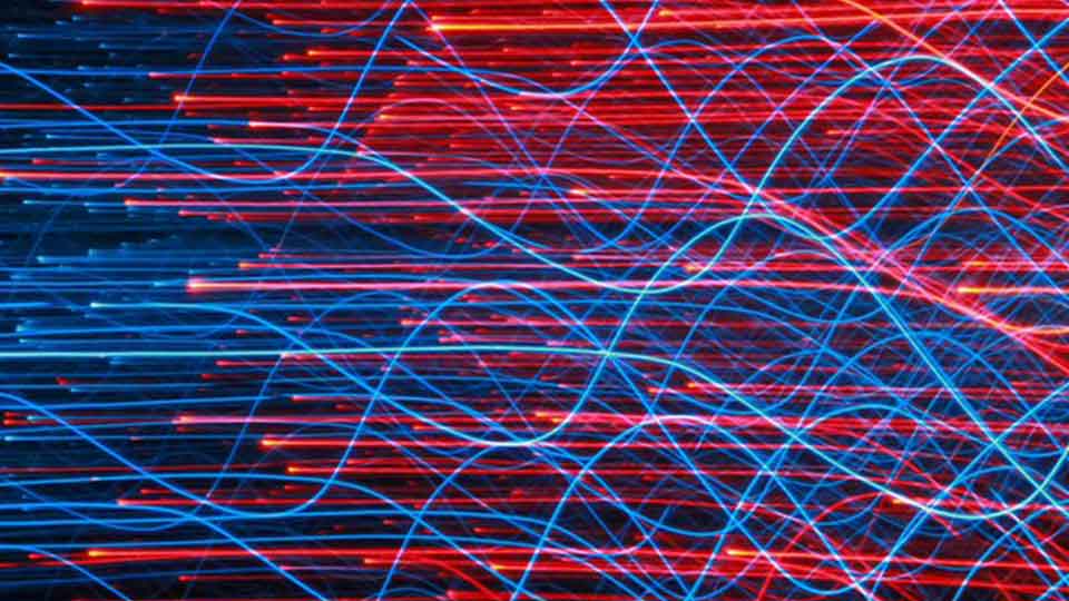 Computer-generated abstract image of blue and red wavy lines on a black background.