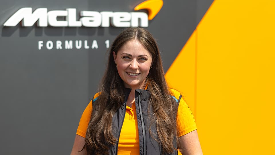 Abbie next to Mclaren Formula 1 logo
