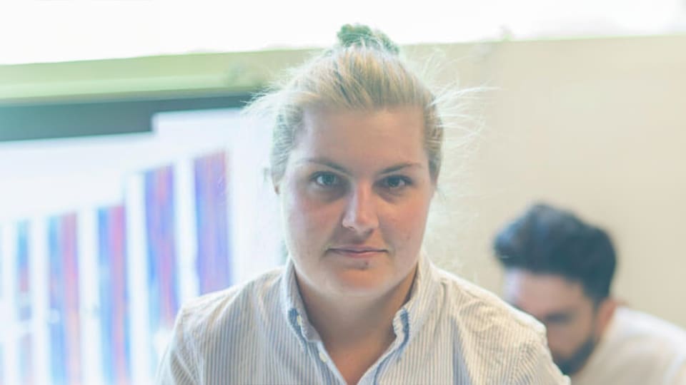 Caroline stood next to a window