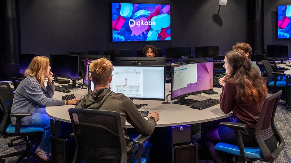 Students in university digi lab working at computers